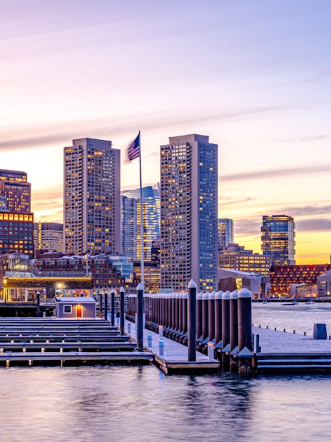 Boston downtown skyscrapers at sunset viewed from the waterfront.