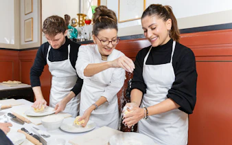 Cooking class participants making pasta near Piazza Navona, Rome.