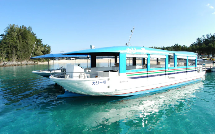 Glass-bottom boat on Okinawa Hip Hop Bus Tour near Churaumi Aquarium.
