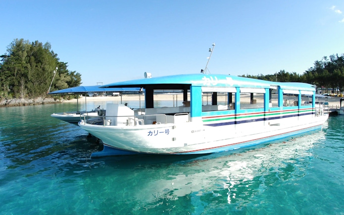 Glass-bottom boat on Okinawa Hip Hop Bus Tour near Churaumi Aquarium.