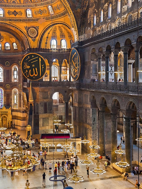 Hagia Sophia interior with ornate chandeliers and Arabic calligraphy, Istanbul.