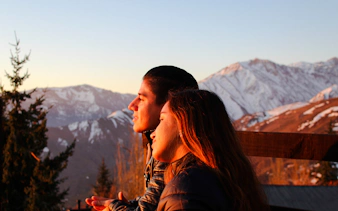 Couple enjoying sunset over the Andes Mountains, Santiago.