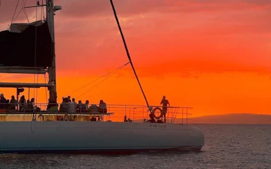 Tourists on a boat enjoying a sunset in Mallorca.