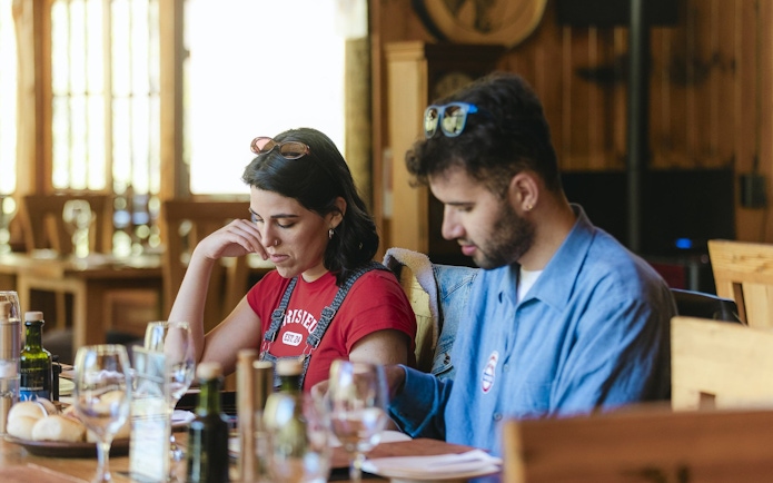 Tourists reviewing menu at Santuario del Río spa and lodge dining area.