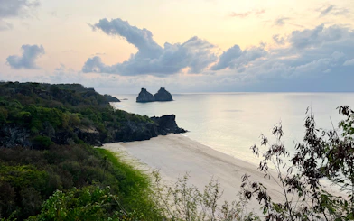 Sancho Beach view with Dois Irmãos rocks at sunset, Fernando de Noronha, Brazil.