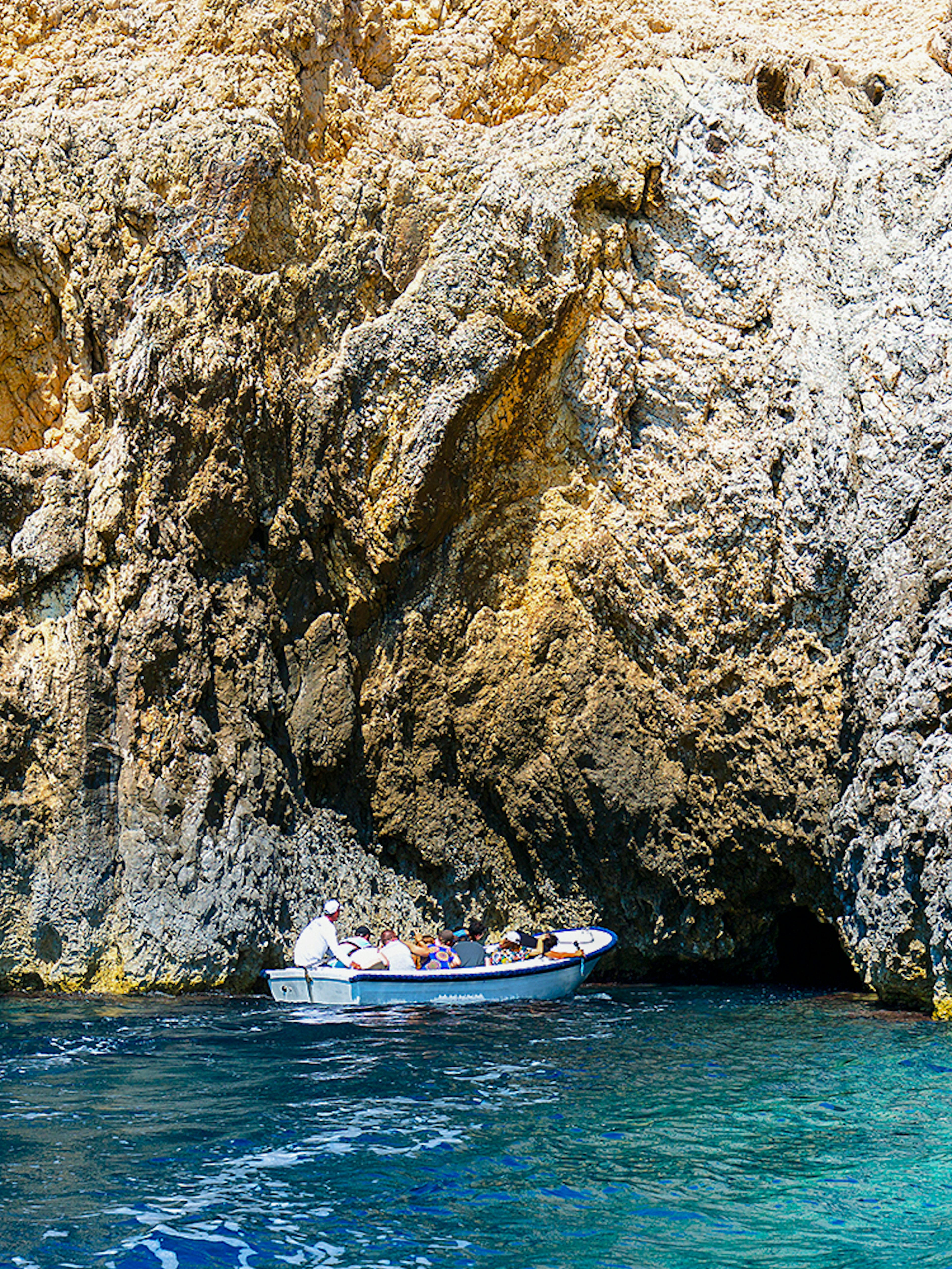 Boat entering Blue Cave on Adriatic Sea, Croatia.