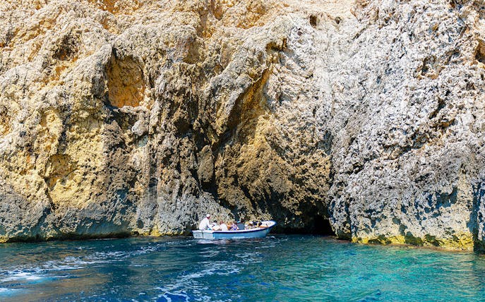 Boat entering Blue Cave on Adriatic Sea, Croatia.