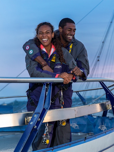 Guests enjoying the view from the O2 rooftop at twilight in London.