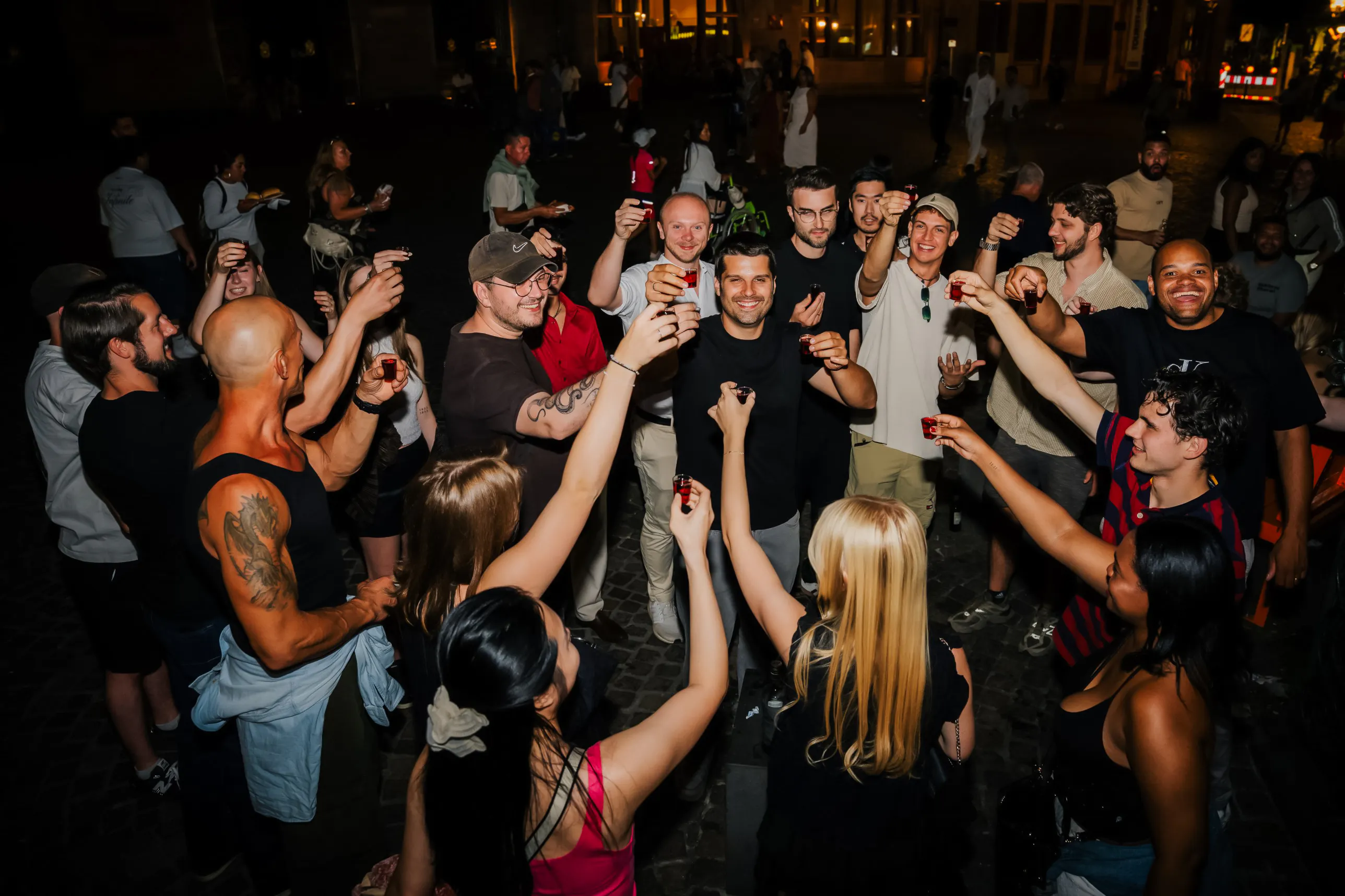 Group enjoying shots during Düsseldorf nightlife tour with club entry.