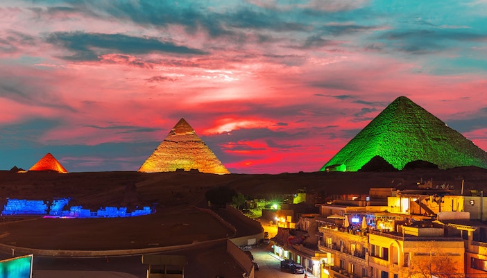 Great Pyramid complex illuminated at night, Giza, Egypt.