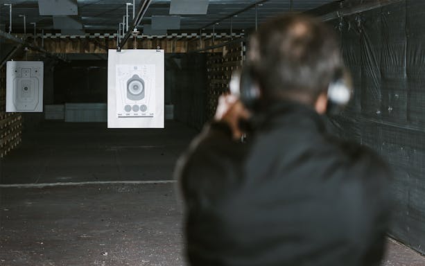 Person aiming at a target in an indoor shooting range in Gdansk.
