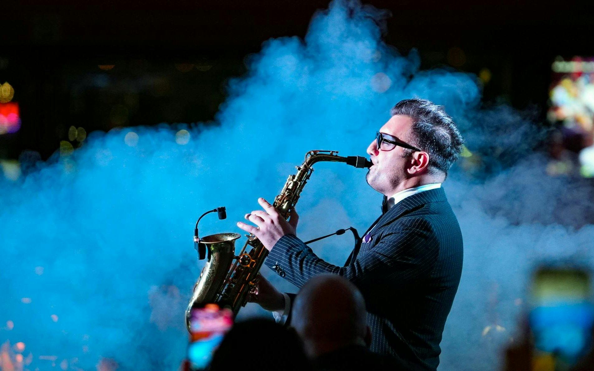 Saxophonist performing on Luxury Bosphorus Dinner Cruise at night.