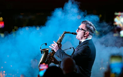 Saxophonist performing on Luxury Bosphorus Dinner Cruise at night.