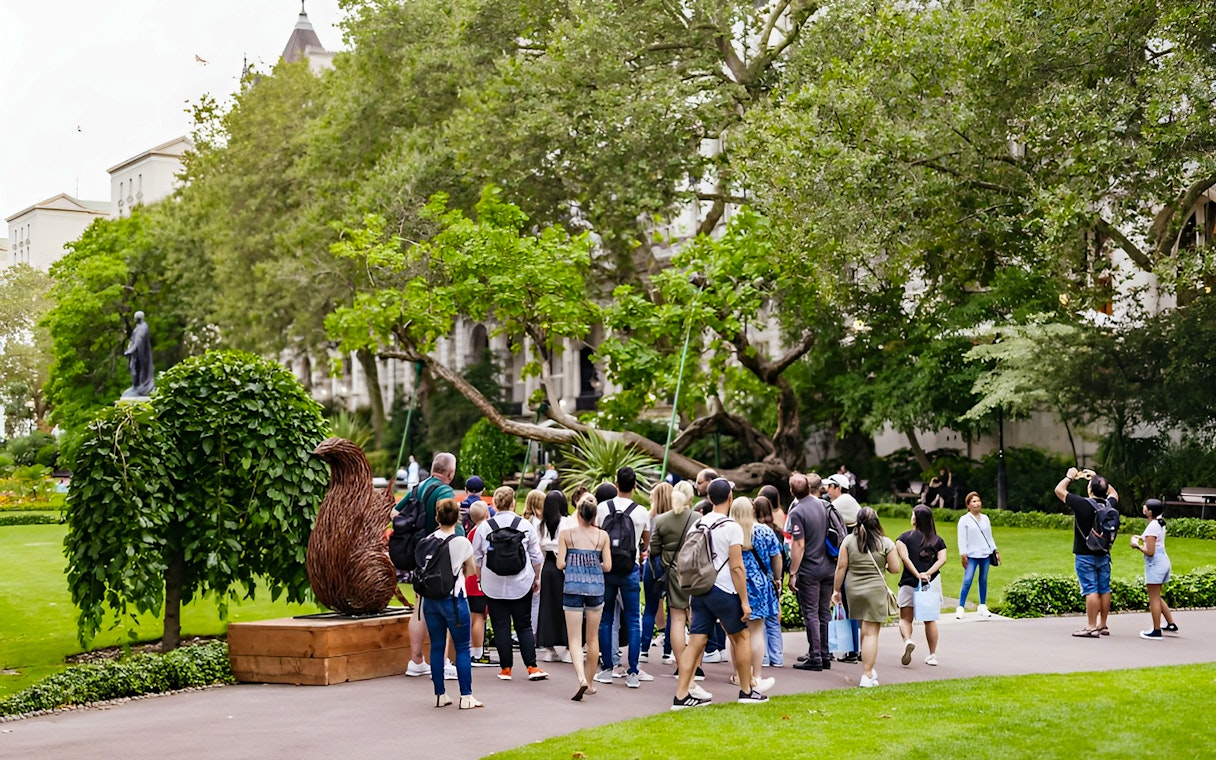 Group of tourists on a Harry Potter London film locations tour in a park setting.