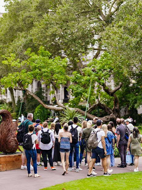 Group of tourists on a Harry Potter London film locations tour in a park setting.