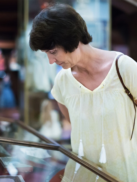 Visitor examining display case at the National Prague Museum.