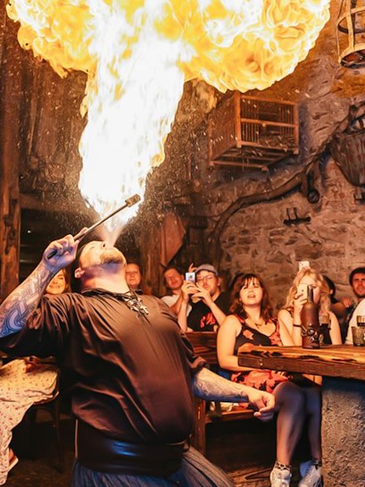 Fire performer entertaining guests at a Medieval Dinner in Prague.