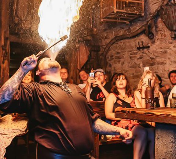 Fire performer entertaining guests at a Medieval Dinner in Prague.