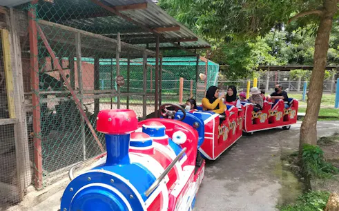 Visitors riding a colorful train at PD Ostrich Show Farm, Dubai.