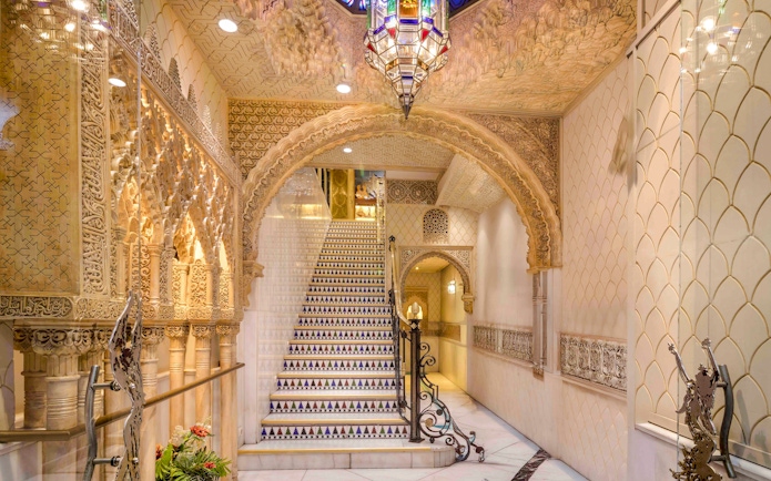 Tablao Cordobes interior with ornate arches and decorative staircase in Barcelona.