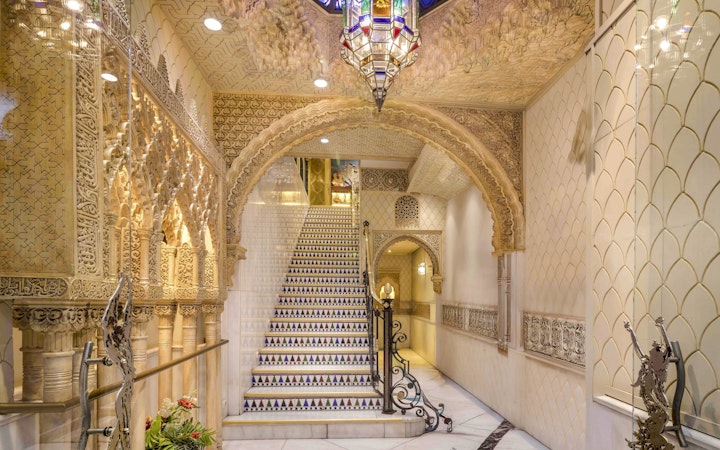 Tablao Cordobes interior with ornate arches and decorative staircase in Barcelona.