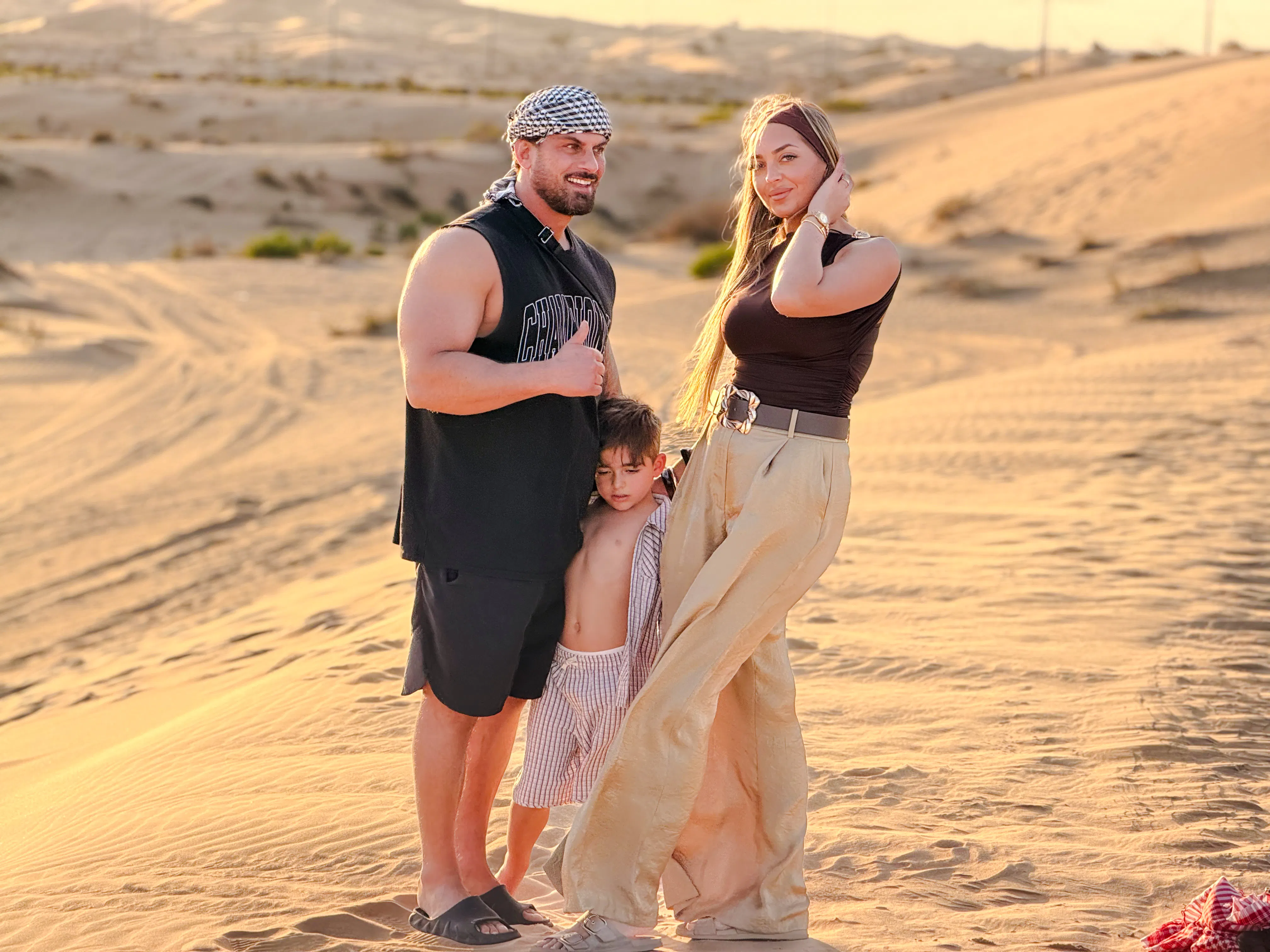 Family enjoying the desert landscape during an evening safari tour in Abu Dhabi.