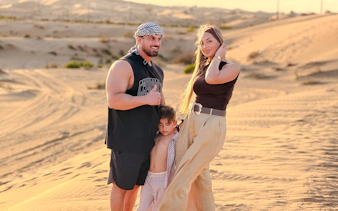 Family enjoying the desert landscape during an evening safari tour in Abu Dhabi.
