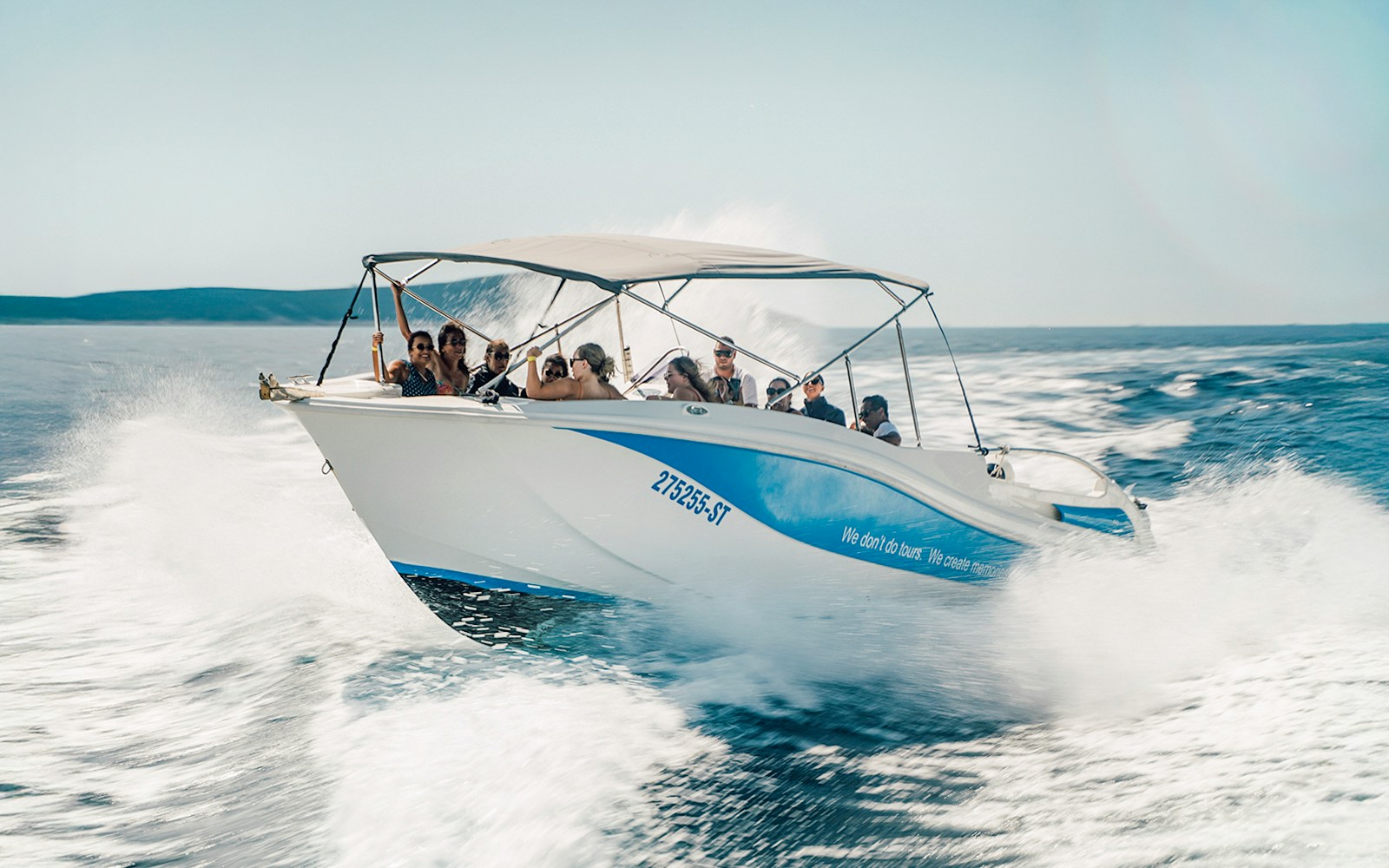 Guests speedboating in Blue Lagoon, enjoying the ride on a sunny day.