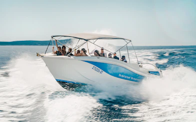 Guests speedboating in Blue Lagoon, enjoying the ride on a sunny day.