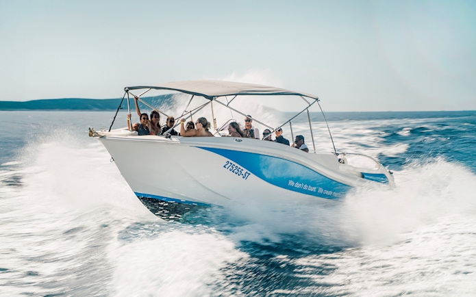 Guests speedboating in Blue Lagoon, enjoying the ride on a sunny day.