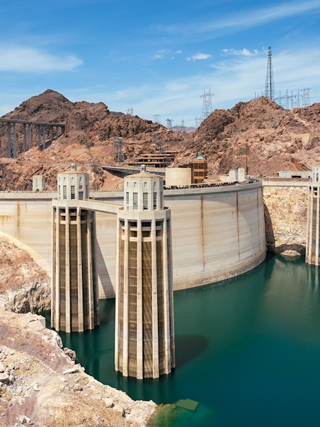 Hoover Dam with surrounding rocky landscape and bridge in Nevada.