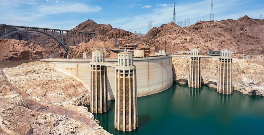 Hoover Dam with surrounding rocky landscape and bridge in Nevada.