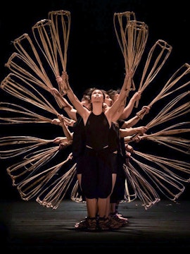 Performers holding baskets in formation at A O Show circus, Vietnam.