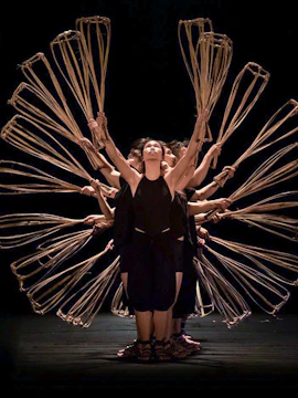 Performers holding baskets in formation at A O Show circus, Vietnam.