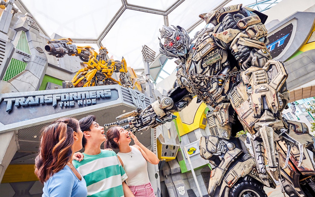 Visitors interacting with Transformers character at Universal Studios Singapore.