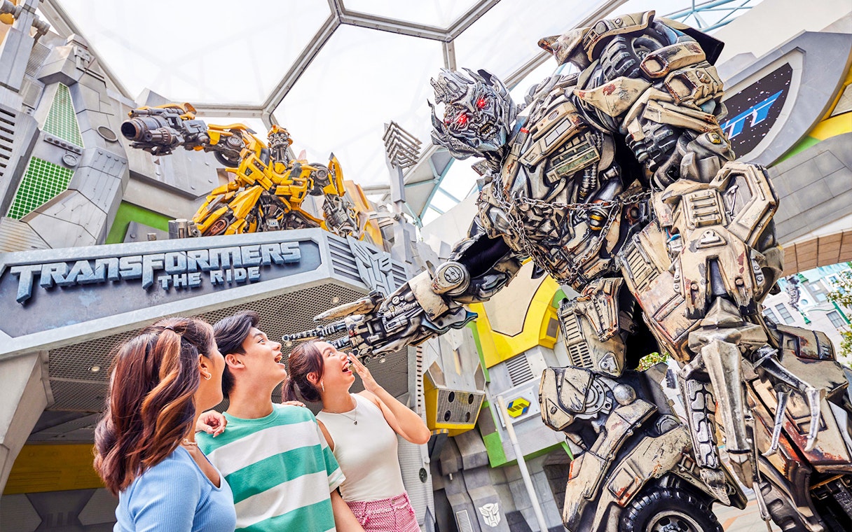 Transformers ride entrance at Universal Studios Singapore with Optimus Prime statue.