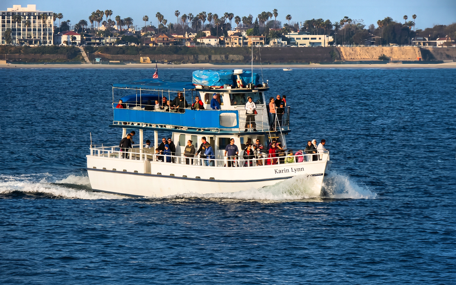 Sightseeing cruise boat with passengers in Los Angeles Harbor.