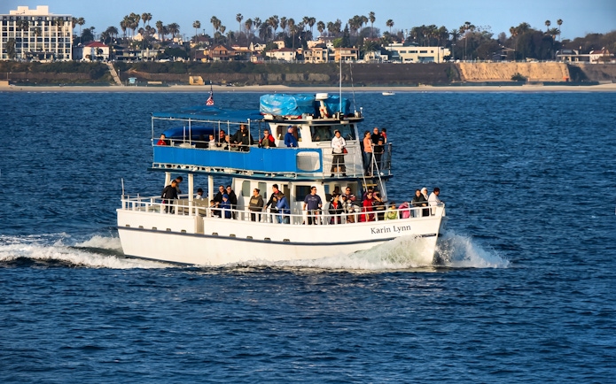 Sightseeing cruise boat with passengers in Los Angeles Harbor.