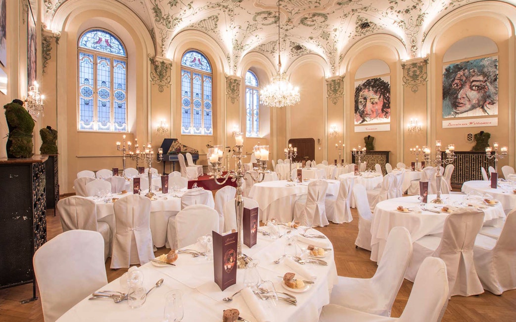 Elegant dining hall in Salzburg set for a Mozart concert with three-course dinner.