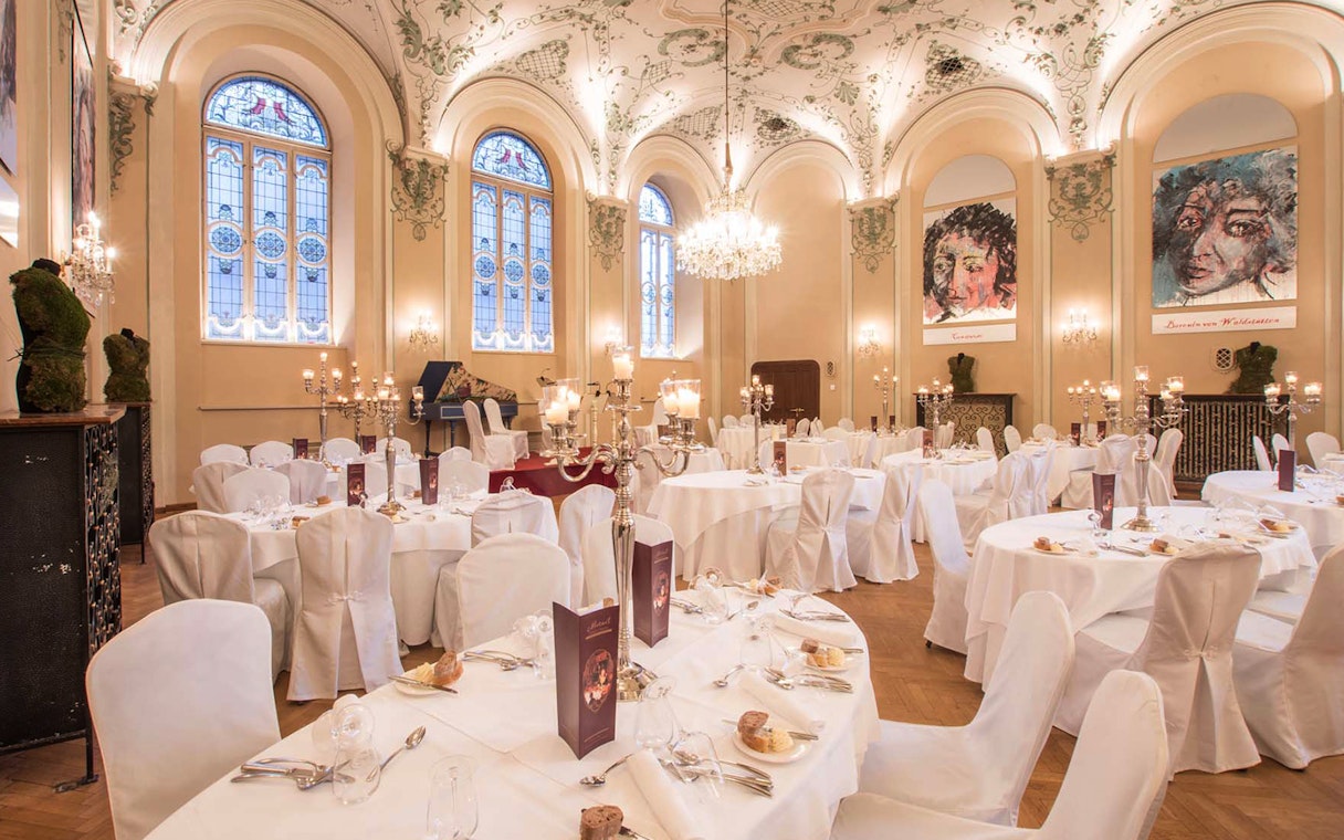 Elegant dining hall in Salzburg set for a Mozart concert with three-course dinner.