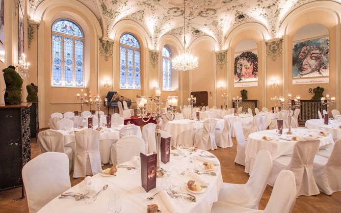 Elegant dining hall in Salzburg set for a Mozart concert with three-course dinner.