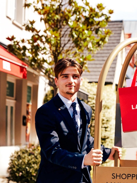 Shopping at La Vallee Village, Paris with Lancel bags on a cart.