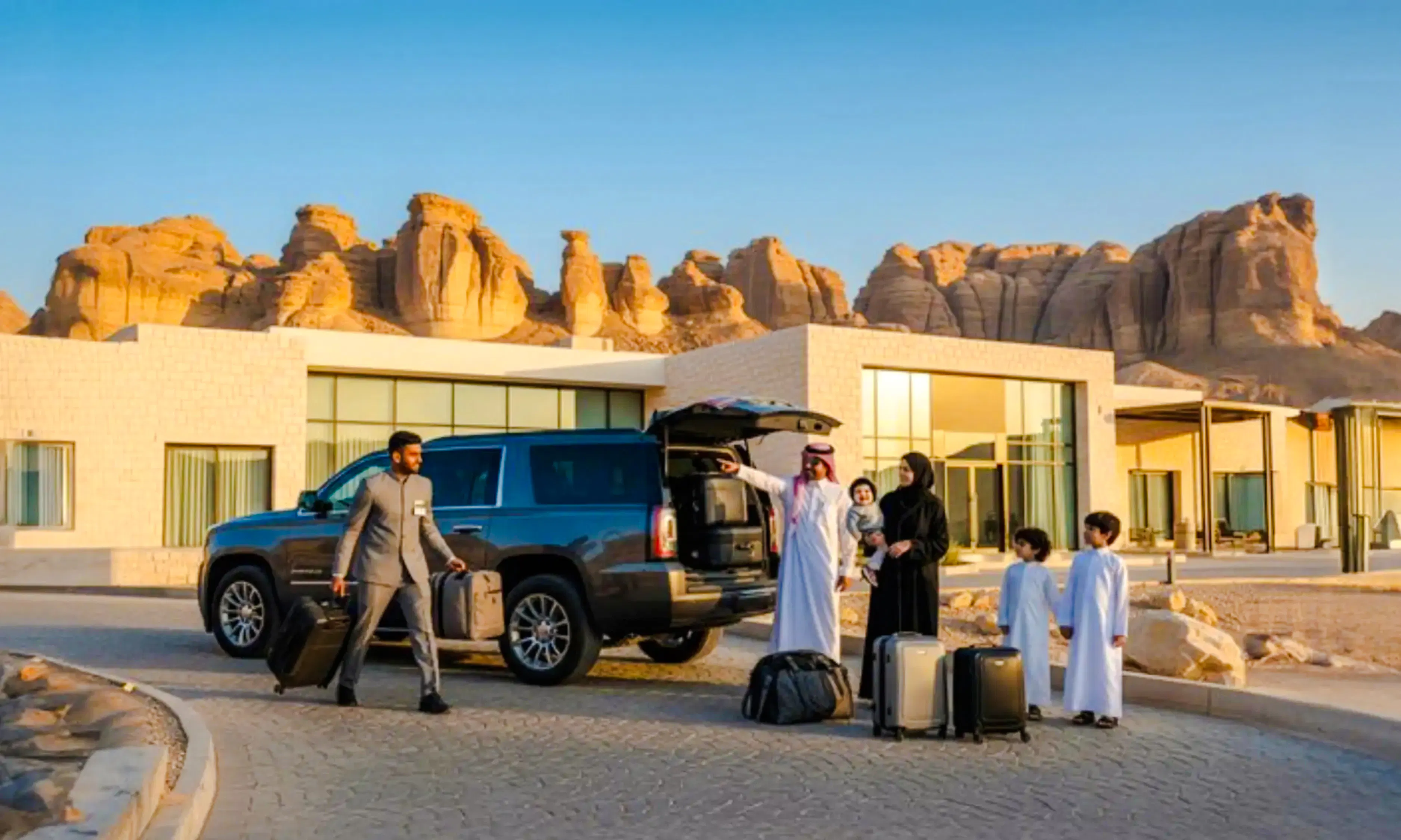 Family with luggage at AlUla private airport transfer, Medina desert backdrop.