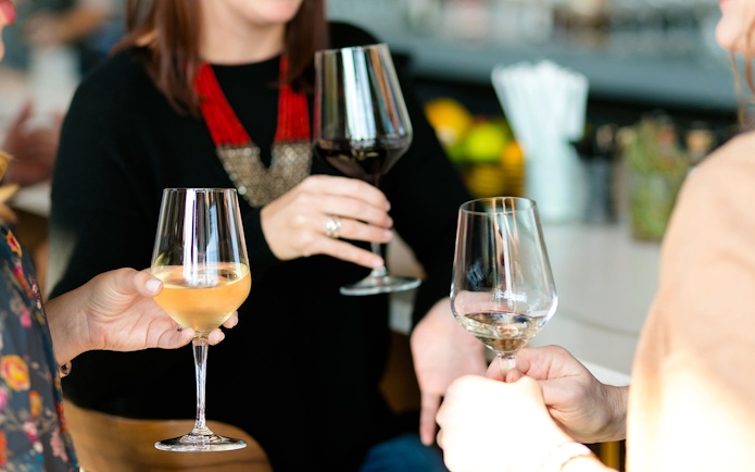 Wine glasses raised during Etna wine tasting tour from Taormina.