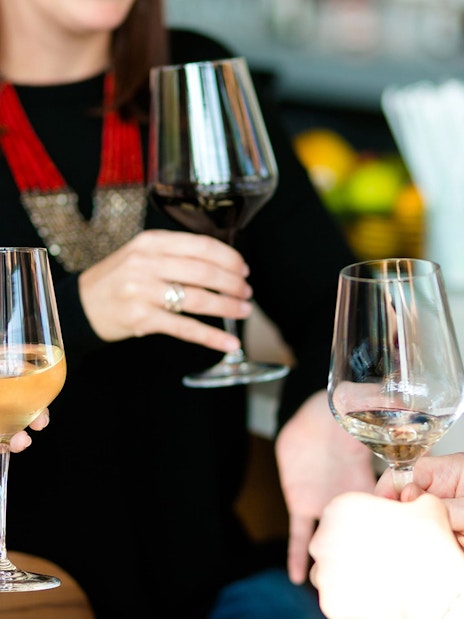 Wine glasses raised during Etna wine tasting tour from Taormina.
