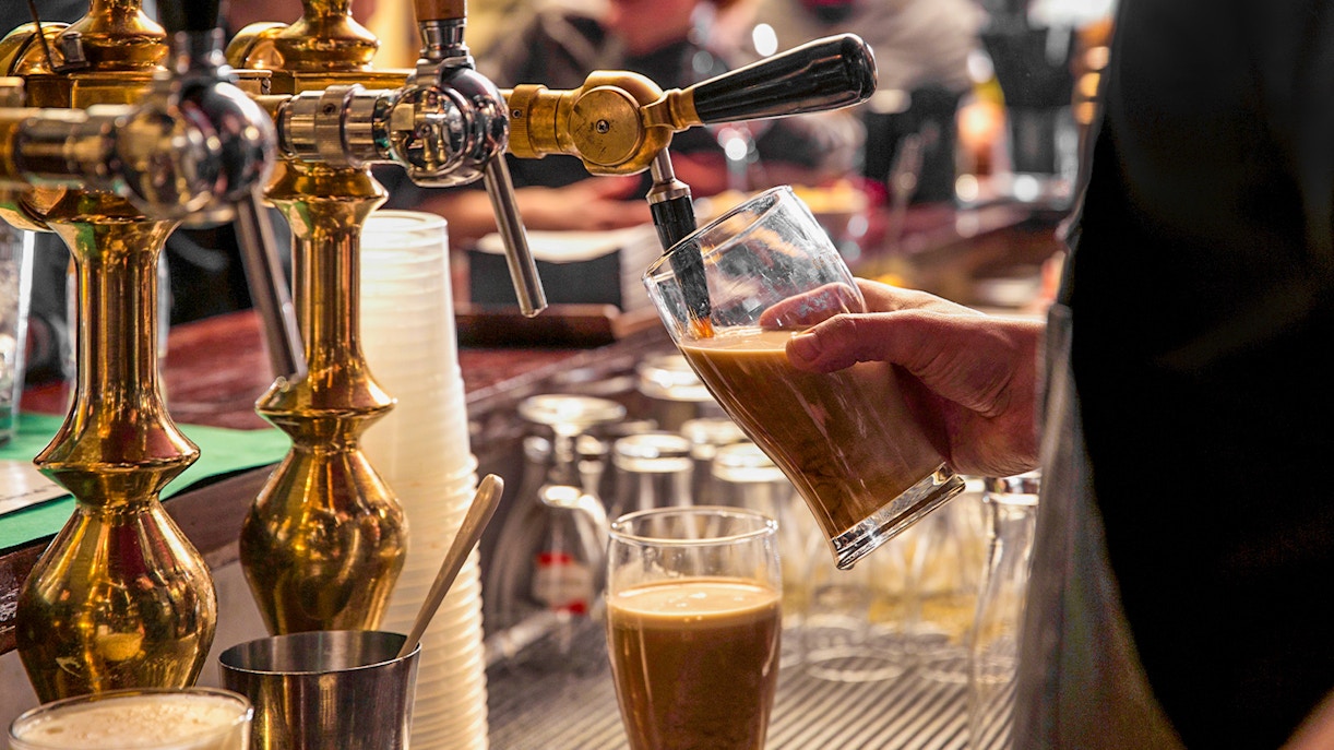 A closeup of beer being served at a pub