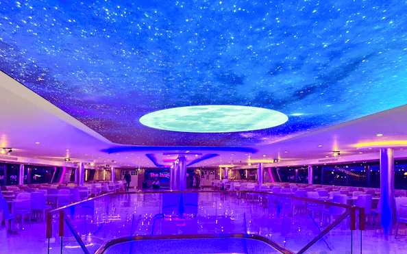 Luxury White Cruise ship interior with starry ceiling and elegant seating.