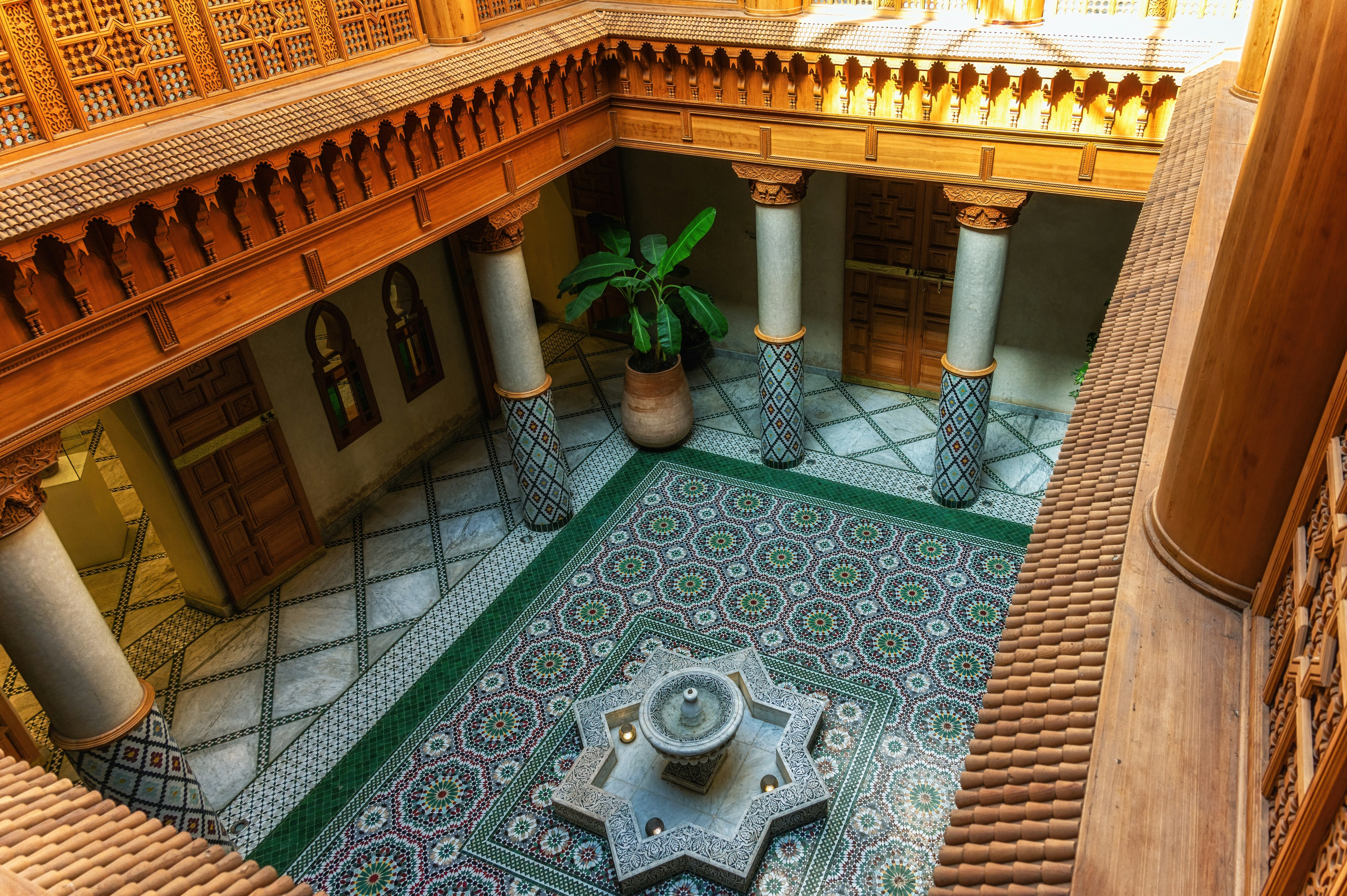 Moroccan Culinary Arts Museum interior with ornate tiles and central fountain.