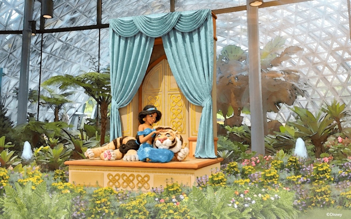 Jasmine with Rajah in a garden setting at a themed attraction.