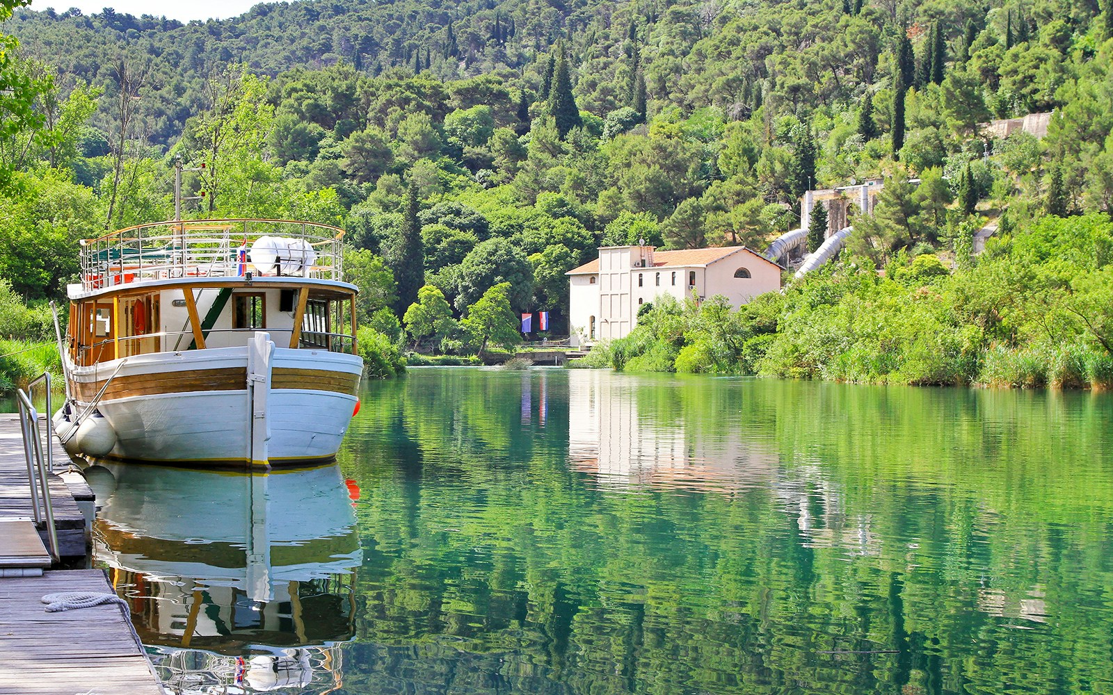 Jaruga Hydroelectric Power Plant at Krka National Park, Croatia, with surrounding lush greenery.